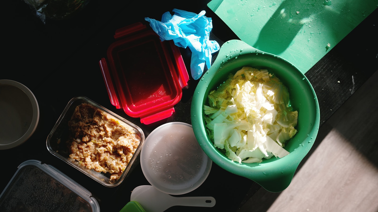 Colorful whole foods including vegetables, beans, whole grains, fruit, nuts and olive oil in front of de-emphasized sugary drinks, refined snacks and processed meats.