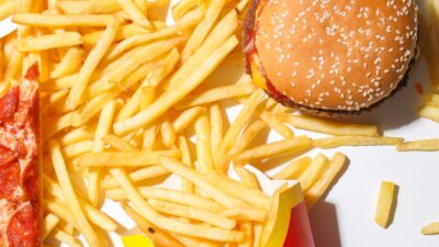 Burger, fries and pizza illustrating rich foods that some people may tolerate poorly on GLP-1