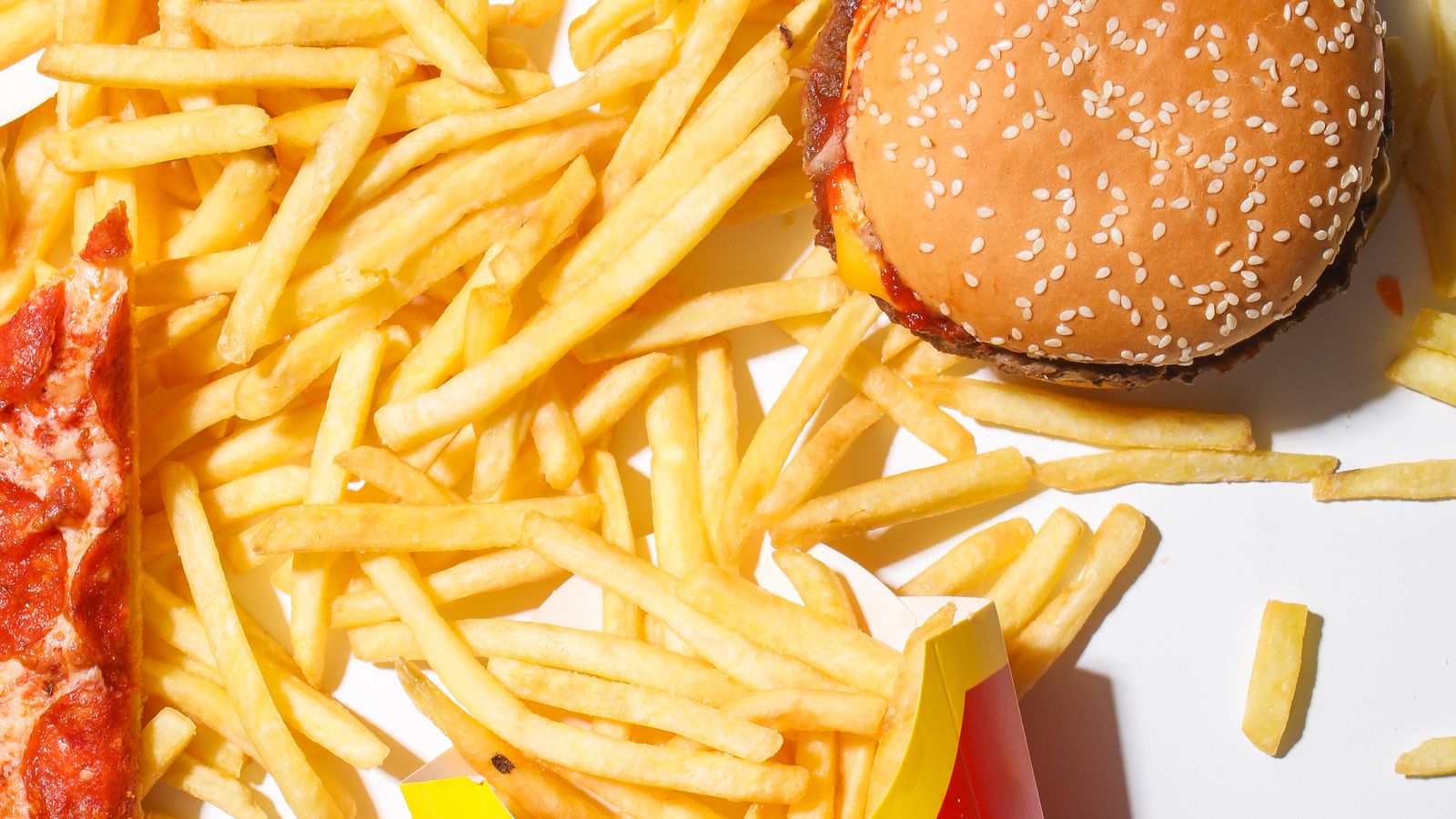 Burger, fries and pizza illustrating rich foods that some people may tolerate poorly on GLP-1