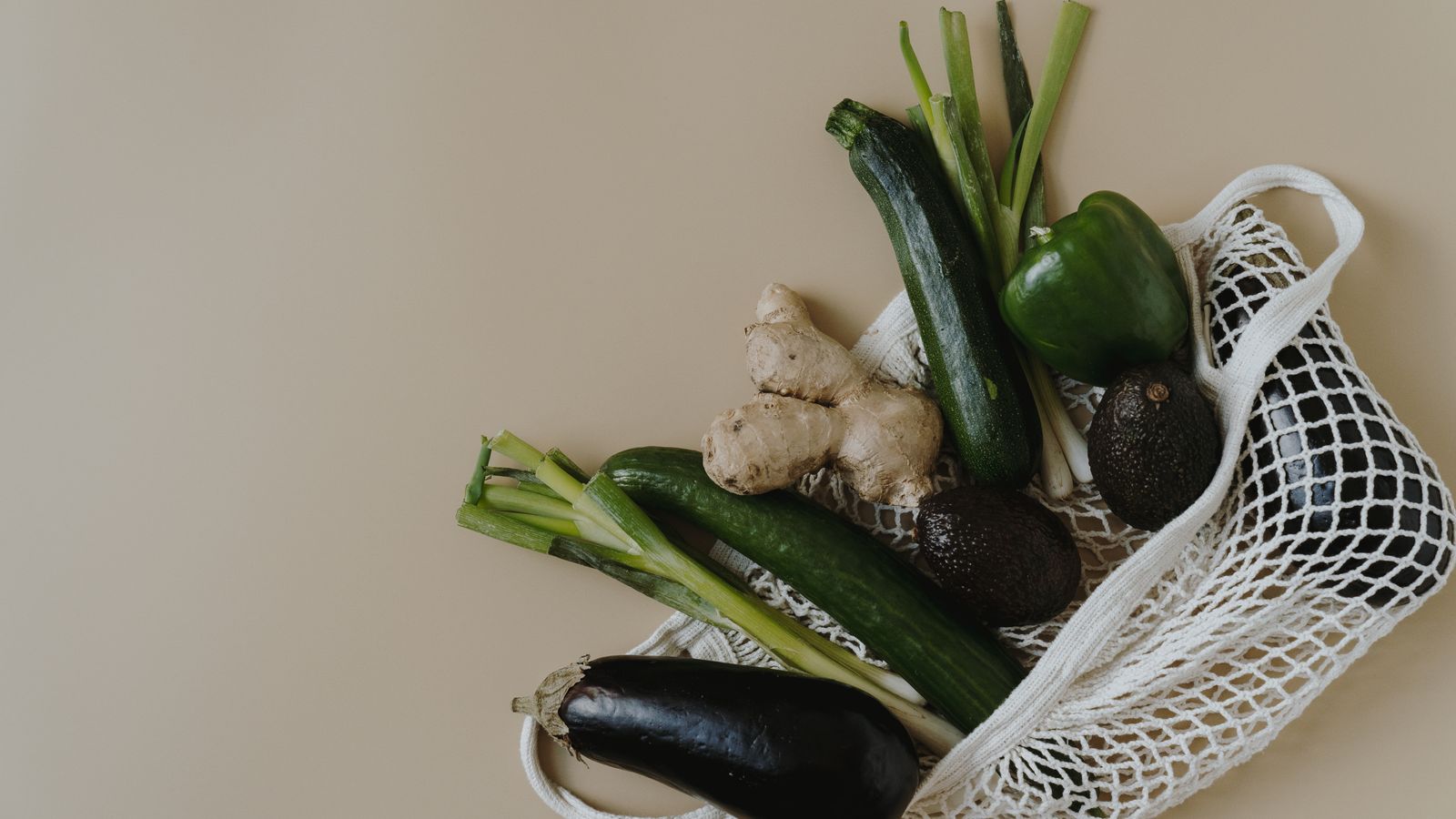 Reusable grocery bag filled with fresh vegetables and fruit for a practical GLP-1 grocery list