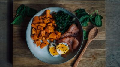 Balanced modest meal with salmon, egg and sweet potato illustrating flexible GLP-1 portion sizes